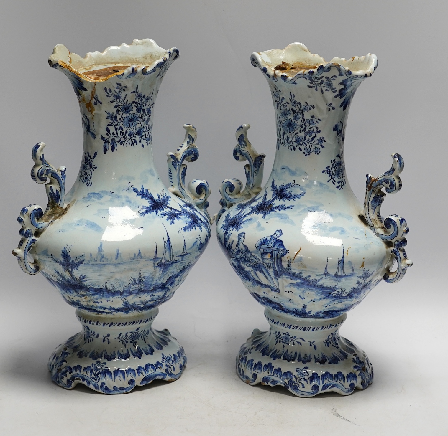 A pair of 19th century Delft blue and white vases, 35cm high. Condition - poor